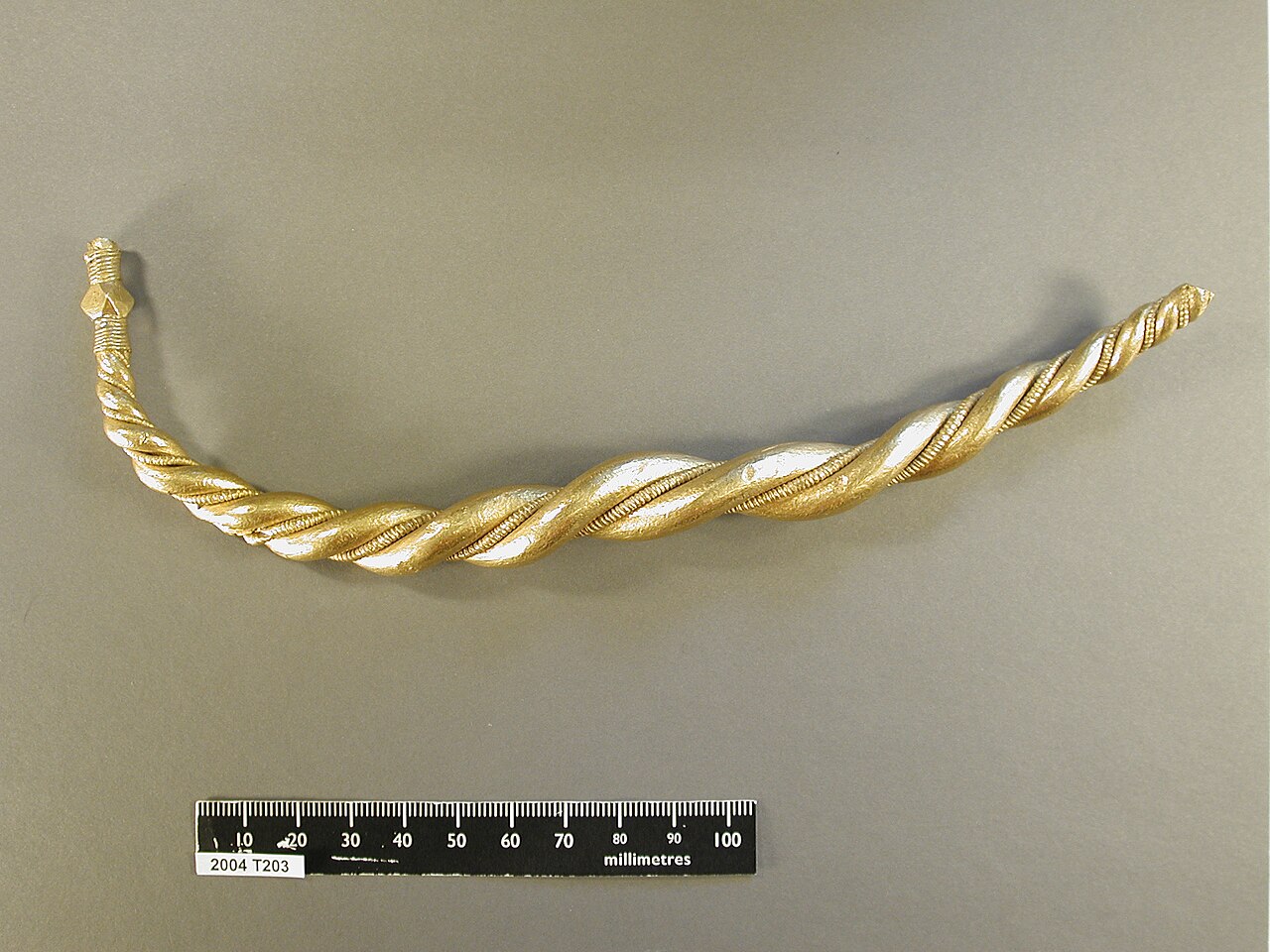 Twisted gold Viking arm ring made from two gold rods twisted together