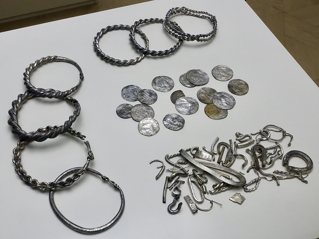 Viking silver hoard with coins, arm rings and hacksilver found at Teisen, Norway