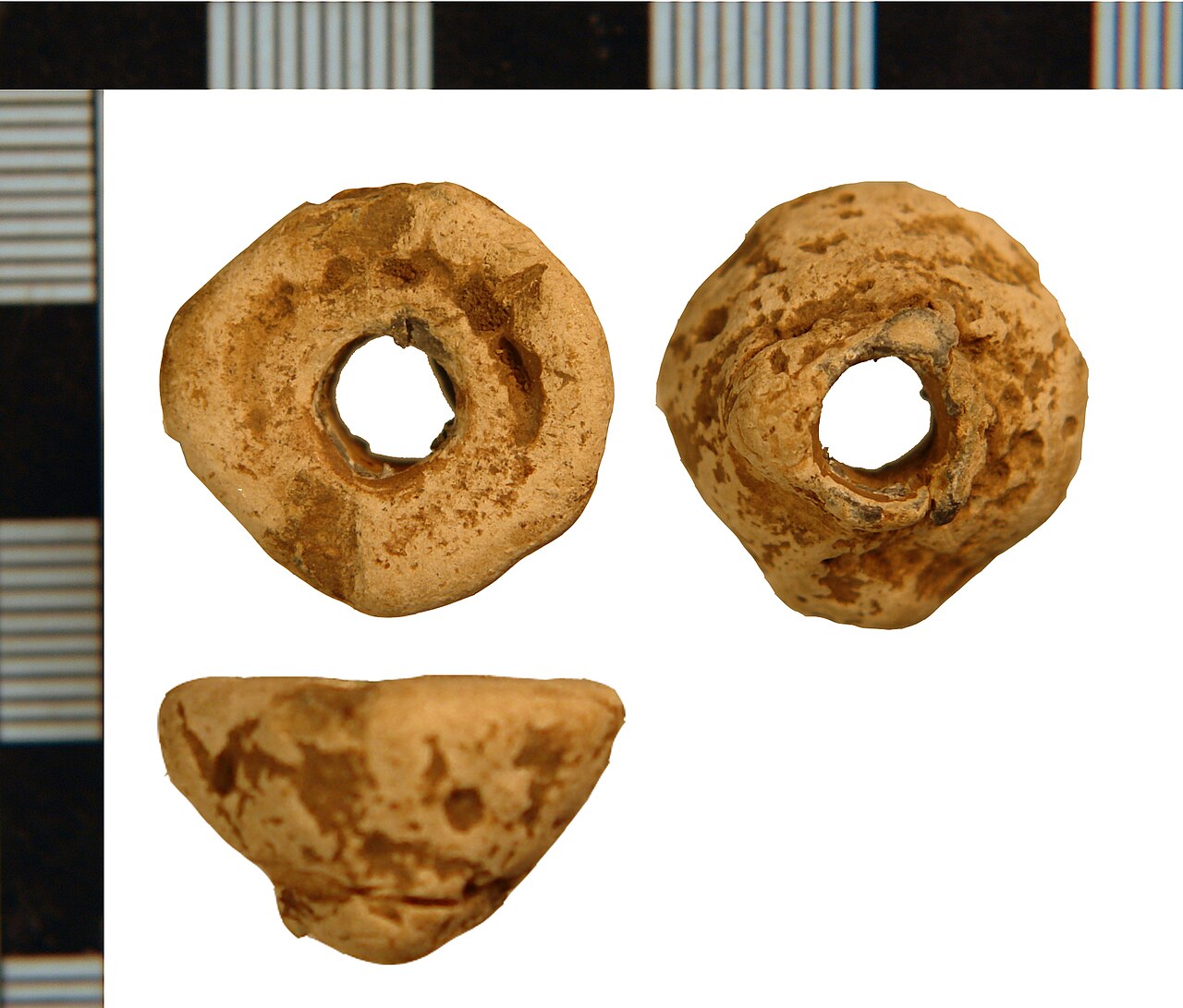 Viking Age lead spindle whorl artifact used to spin wool into thread