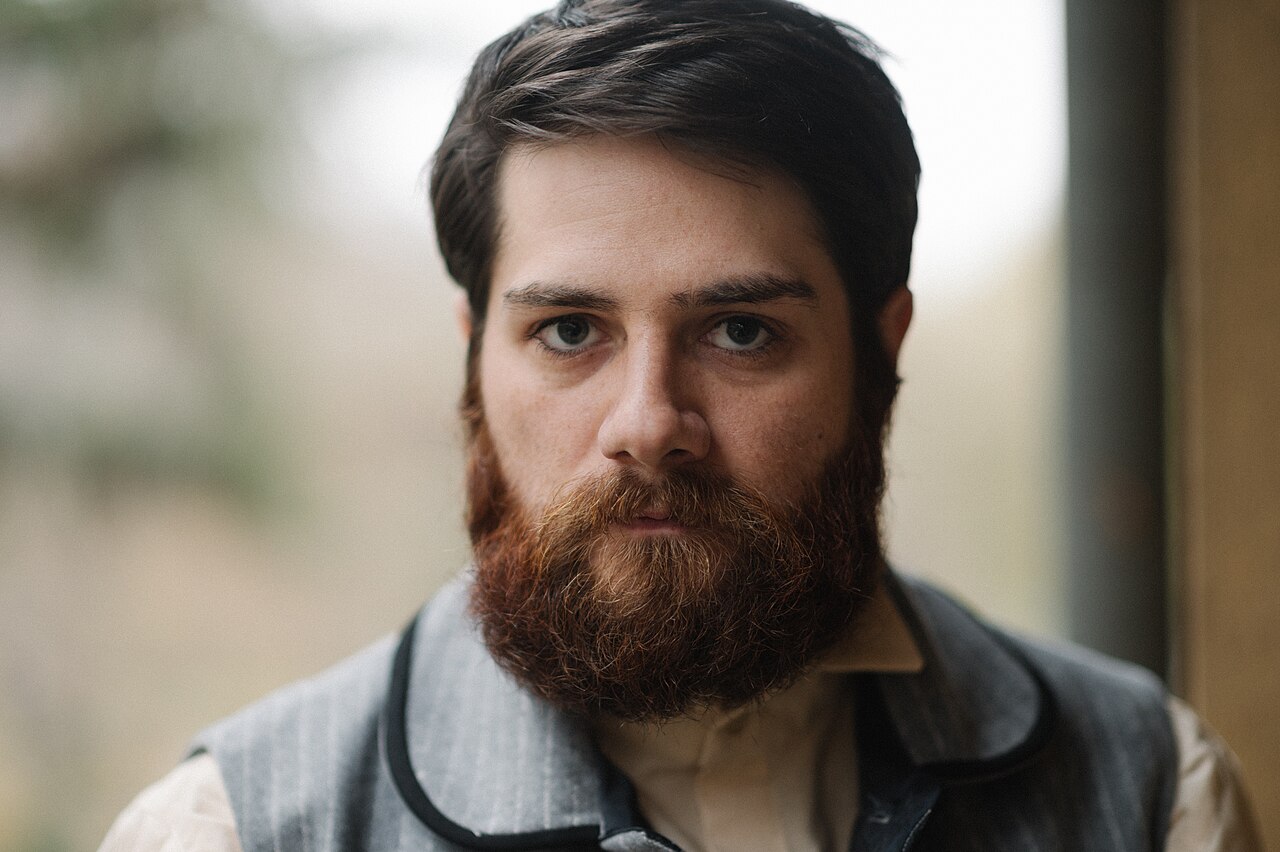 Man with a full, well-groomed square beard illustrating classic viking beard styles