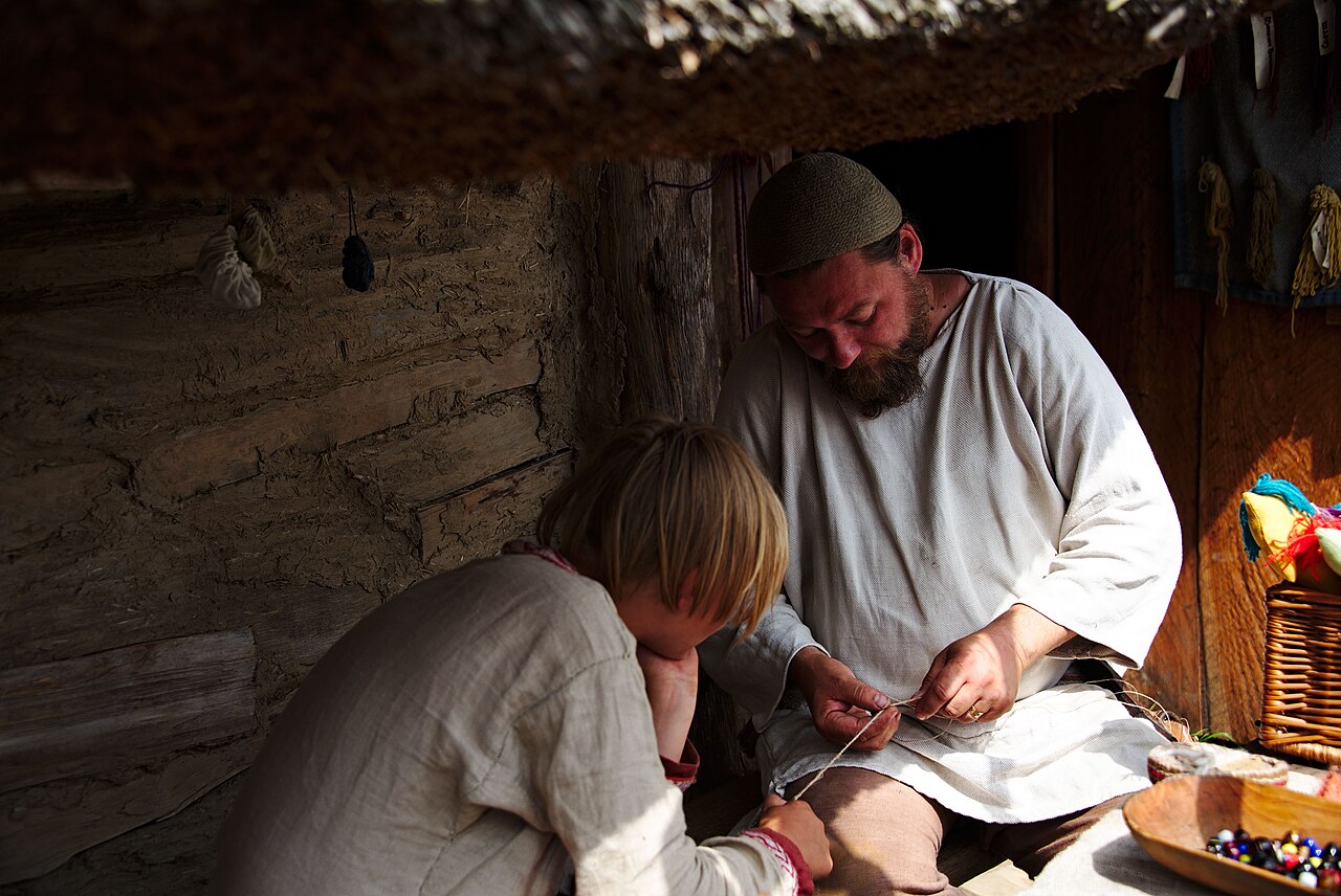 Viking reenactor with shaved-side undercut and long braided ponytail, a modern viking hairstyle for men